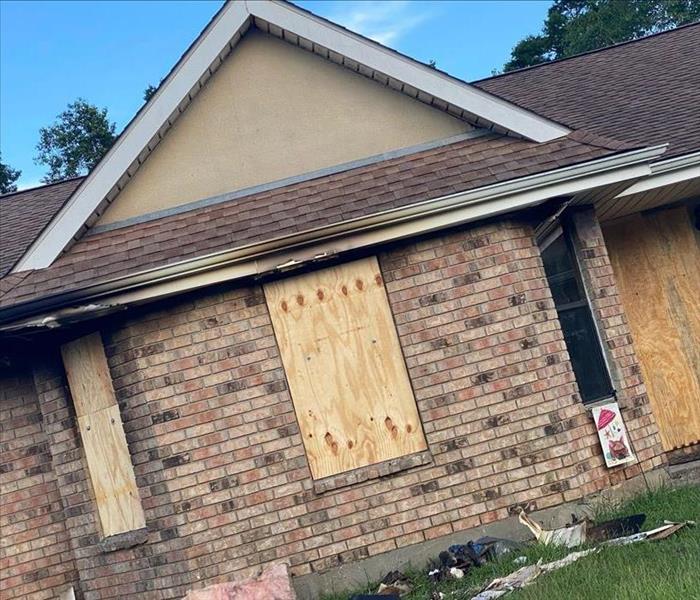 House with boarded up windows and door