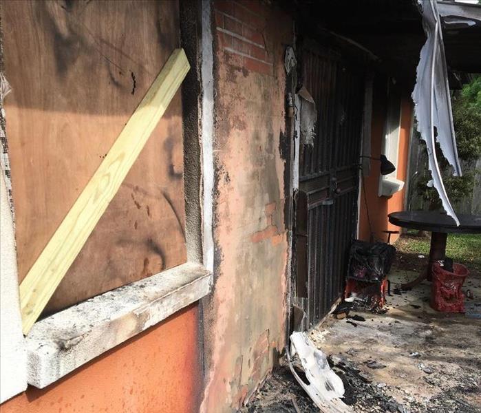 Front of charred house with fire damage