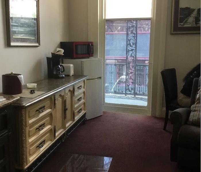  Hotel room with open door and view of courtyard