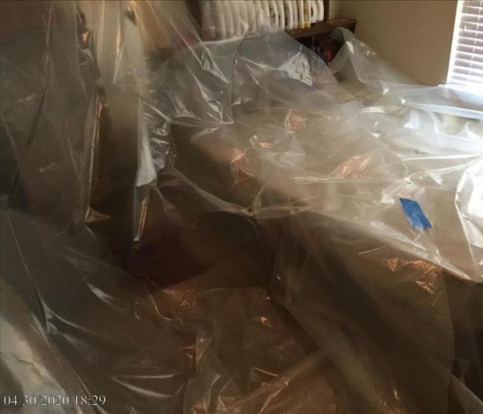 Office furniture covered in a protective layer of plastic sheeting