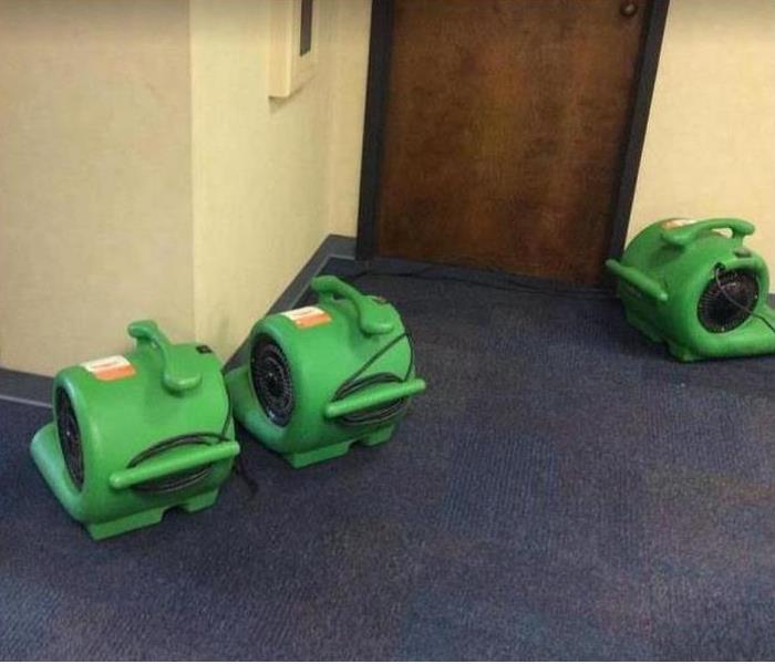 water damaged carpet; SERVPRO drying equipment being used